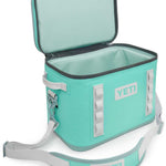 Yeti Hopper Flip 18 Personal Cooler - A light blue cooler with a zipper closure and two gray handles on either side, viewed from the front at an angle.
