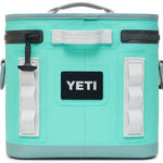 Yeti Hopper Flip 8 Personal Cooler - A mint green cooler with a handle on top and two zippered compartments, one in front and one on the side.