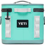 Yeti Hopper Flip 8 Personal Cooler - A mint green cooler with a handle on top and two zippered compartments, one in front and one on the side.