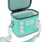 Yeti Hopper Flip 8 Personal Cooler - A mint green cooler with a zippered lid and two handles on either side, featuring a white logo that reads "YETI" in block letters.