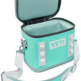 Yeti Hopper Flip 8 Personal Cooler - A mint green cooler with a zippered lid and two handles on either side, featuring a white logo that reads "YETI" in block letters.