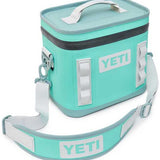 Yeti Hopper Flip 8 Personal Cooler - A mint green cooler with a zippered lid and two handles, featuring a white logo on the front.