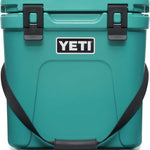 Yeti Roadie 24 Hard Cooler - A compact, portable cooler with a sleek design and a silver handle on top.