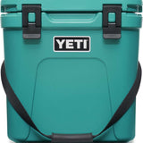 Yeti Roadie 24 Hard Cooler - A compact, portable cooler with a sleek design and a silver handle on top.
