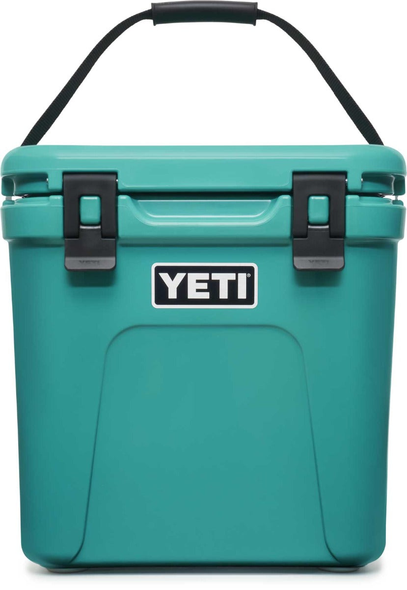 Yeti Roadie 24 Hard Cooler - A compact, portable cooler with a sleek design and a silver handle on top.