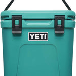 Yeti Roadie 24 Hard Cooler - A compact, portable cooler with a sleek design and a silver handle on top.