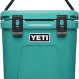 Yeti Roadie 24 Hard Cooler - A compact, portable cooler with a sleek design and a silver handle on top.