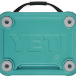 Yeti Roadie 24 Hard Cooler - A turquoise cooler with a handle on top and four feet at the bottom.