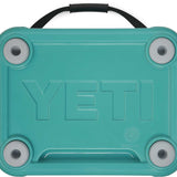 Yeti Roadie 24 Hard Cooler - A turquoise cooler with a handle on top and four feet at the bottom.