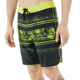 Oakley Men's Temples 19" Swim Board Shorts 2018 - Black swim trunks with a palm tree pattern and lime green accents.