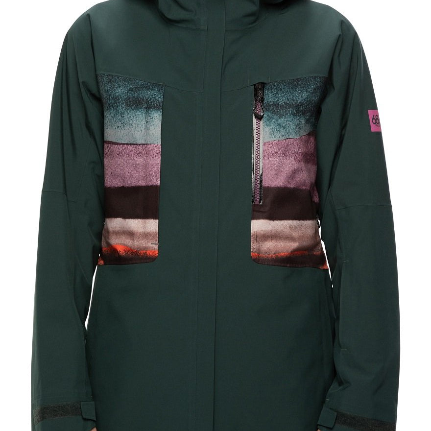 The 686 GLCR Mantra Insulated Jacket, a dark green jacket with a multicolored panel on the chest and upper back, has an adjustable hood with a faux fur trim.