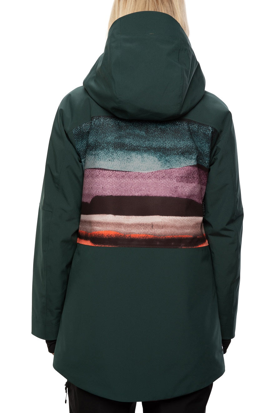 The 686 brand Lady's Glacier Crust Mantra Insulated Jacket 2021 has a dark green color with an abstract design on the back in shades of blue, purple and pink.