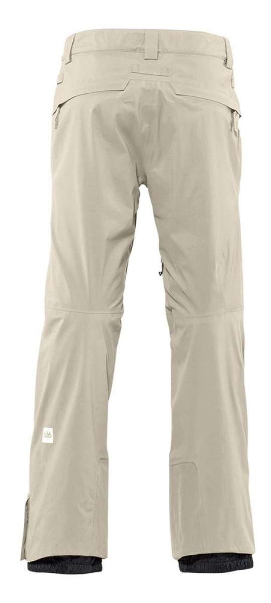 The 686 GLCR Gore-Tex GT Pant 2022 is depicted in a side view with a light tan color and has a distinctive zippered pocket on the right leg.