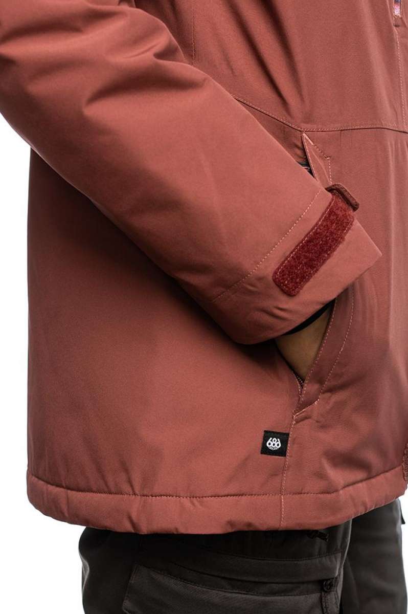 The 686 GLCR Gore-Tex Willow Insulated Jacket 2022 is primarily pink with a brown fleece-lined collar and brown accents on the shoulder straps.