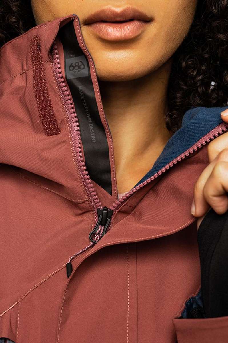 The 686 Ladies GLCR GORE-TEX Willow Insulated Jacket 2022 is primarily a muted burgundy color with a black zipper and an adjustable velcro cuff.