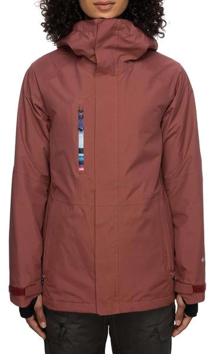 The 686 Ladies GLCR GORE-TEX Willow Insulated Jacket 2022 in dusty rose has a hood and zippered pockets.