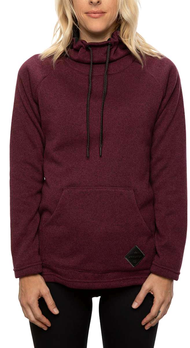 The 686 Balance Pullover Fleece has a maroon color with a black drawstring and a kangaroo pocket.
