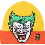A yellow and orange beanie with an embroidered Batman logo on the front in black.