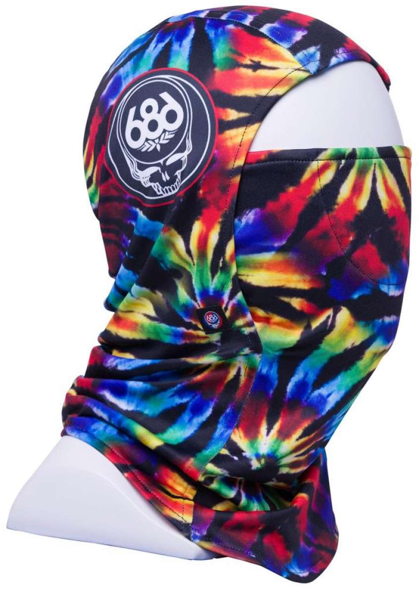 The 686 Deluxe Hinged Balaclava 2024 has a black background with a tie-dye pattern of red, yellow, green, blue, and purple colors.