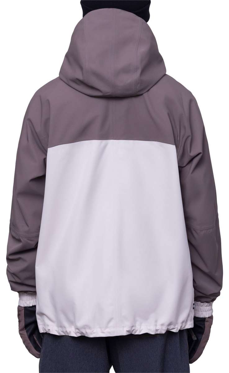 The 686 Dojo Shell Jacket 2024 in this front view has a predominantly gray color scheme with a white panel across the middle and a black hood.