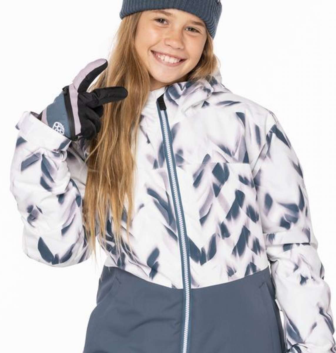 The 686 Girls Athena Insulated Jacket is predominantly white with grey brushstroke-style designs and a blue zipper running down the front.