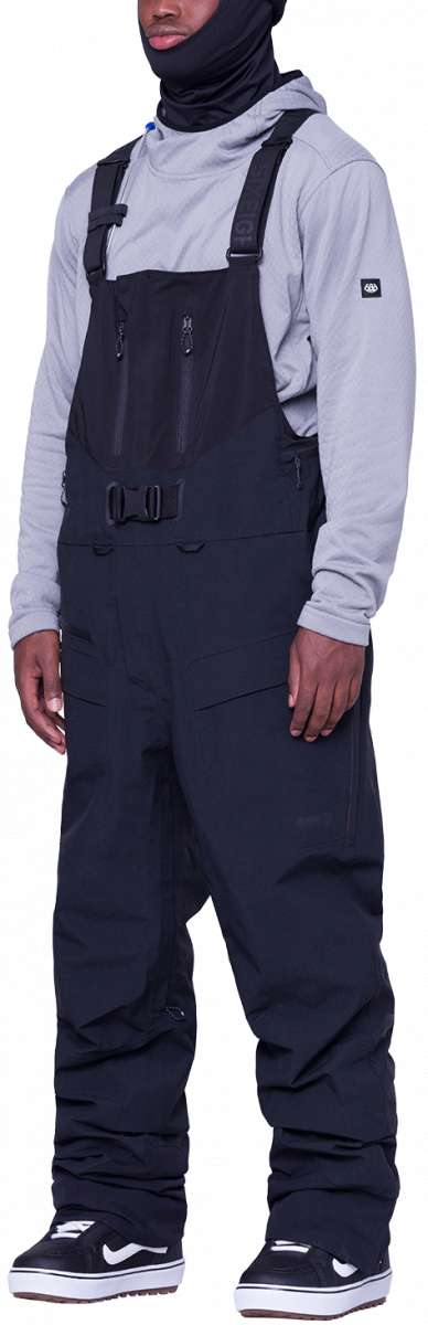 The 686 Gore-Tex Pro 3L Thermagraph Bib Pants in black have a zippered leg pocket and adjustable straps.