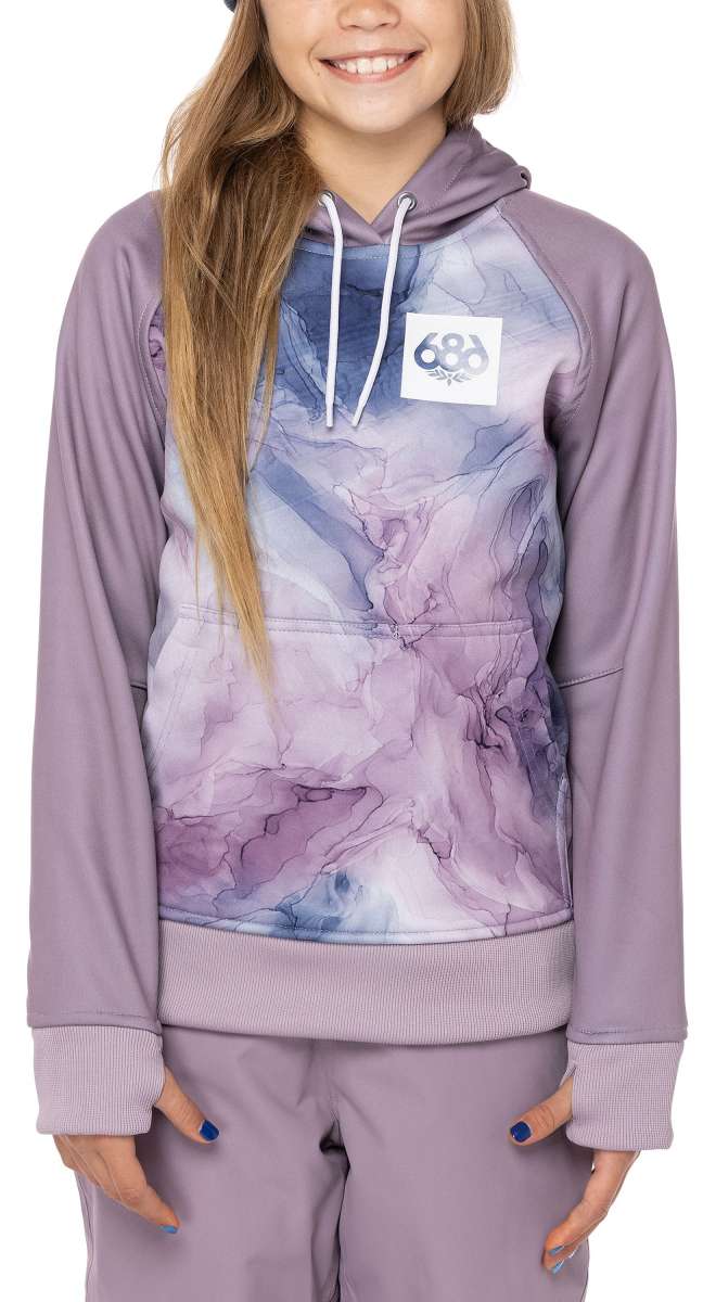 A young girl with long blonde hair wearing a purple and grey 686 hoodie with an insulated hood, smiling at the camera.