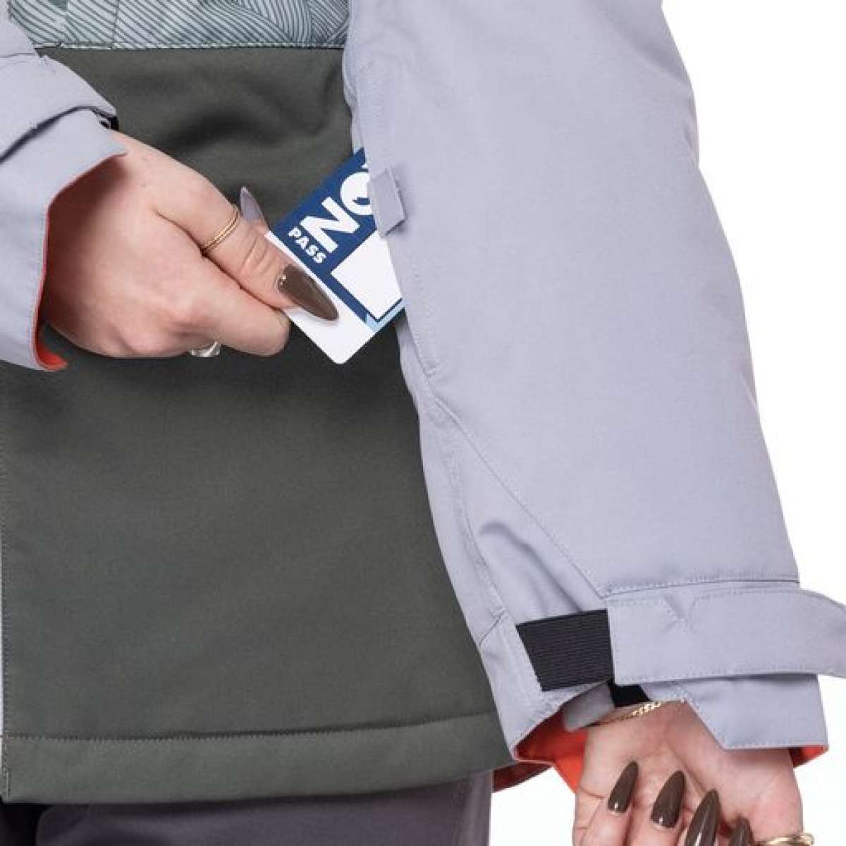 The 686 Women's Athena Insulated Jacket 2022 is light gray with an orange lining and an insulated hood.