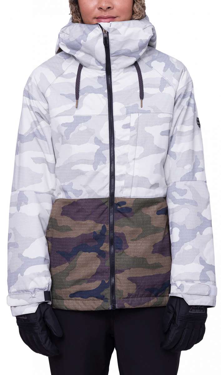 The 686 Women's Athena Insulated Jacket 2024 features a white and grey camouflage pattern with a black zipper running down the front.