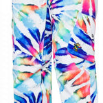 The 686 Women's Aura Insulated Cargo Pant has a white background with a tie-dye pattern in shades of pink, blue, and yellow.