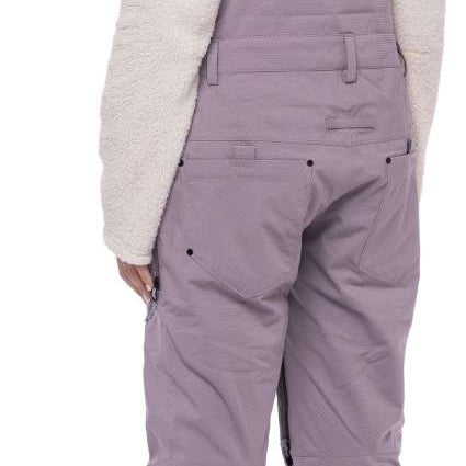 The 686 Black Magic bibs have a black quilted pattern and are fully insulated with a thick white lining.