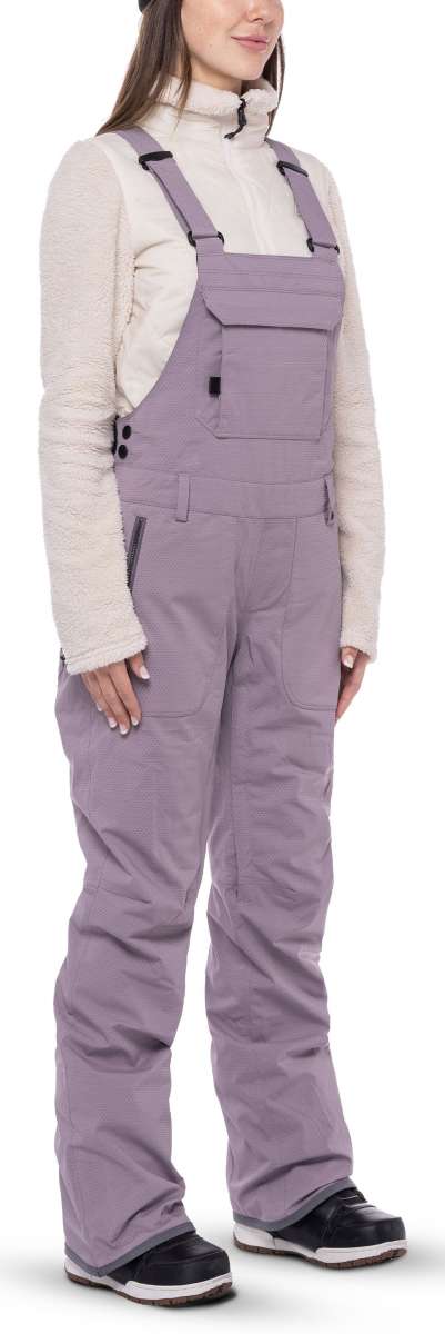 The 686 Black Magic insulated bibs are black with a white pattern.