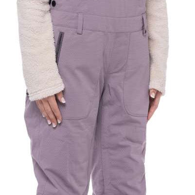 The 686 Black Magic insulated bibs are black with a white pattern.