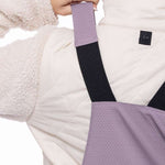 The 686 black bib overalls have an insulated design with quilting on the upper back and black straps.