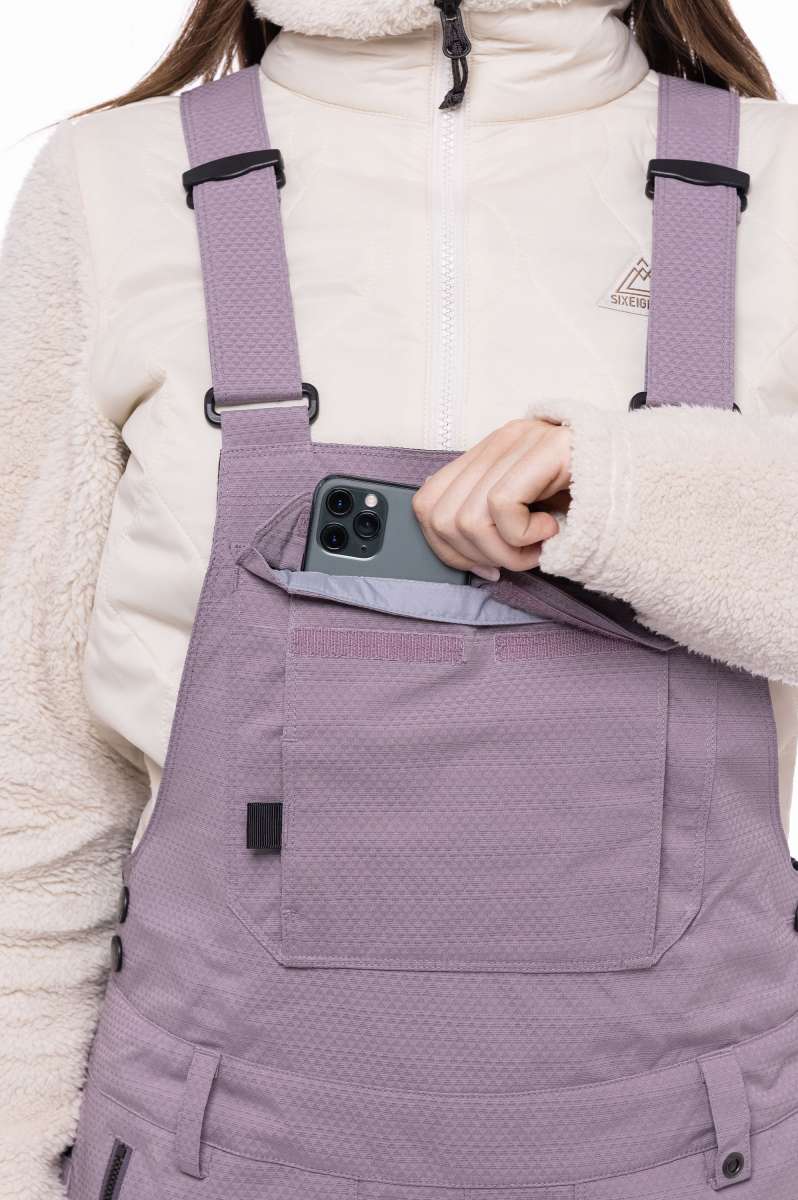 The 686 brand's black bib pants with an insulated design are showcased in this front view.