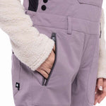 The 686 black bib snowpants have an insulated hood and adjustable velcro straps.