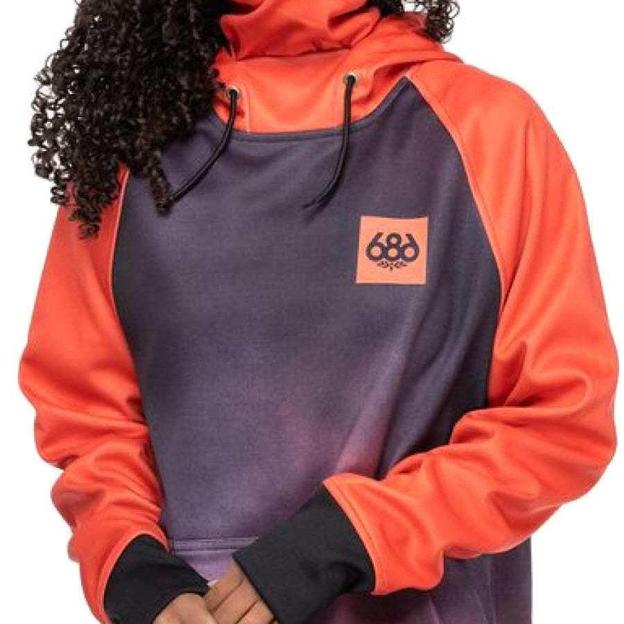 A woman wearing a grey and coral hooded sweatshirt with an orange logo on the front.