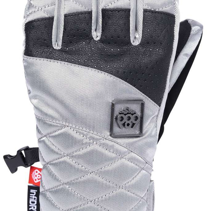 The 686 Fortune glove has a black leather palm and back on a gray quilted fabric with an embossed logo patch above the wrist.