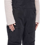 The women's 686 Geode Thermagraph bib features a black insulated snowboard bib with a zippered fly and adjustable straps.