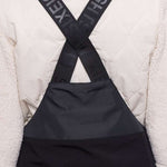 The 686 women's Geode Thermagraph bib has a quilted pattern and is primarily black with grey accents.