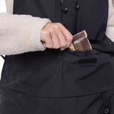 The 686 Women's Geode Thermagraph Bib 2023 has a black bib with a tan waistband and leg straps.