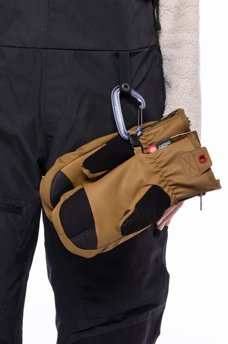 The 686 Women's Geode Thermagraph Bib features black bib pants with a white snowboard boot liner visible at the bottom.