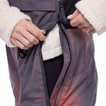 The 686 Women's Geode Thermagraph Bib 2023 in this image appears to be dark purple with an insulated white hood.