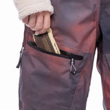 The 686 Women's Geode Thermagraph Bib 2023 is depicted in a side view, showcasing a dark brown color with an insulated hood.