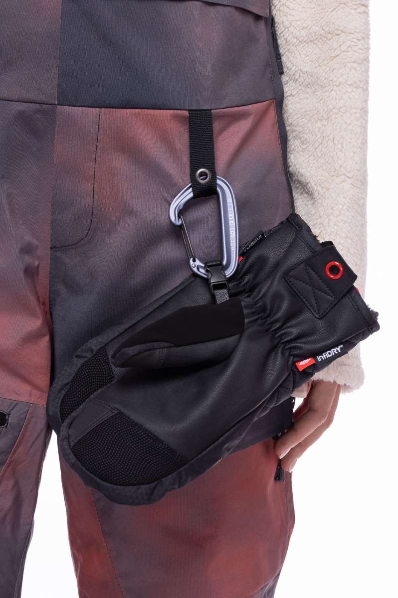 The 686 Women's Geode Thermagraph Bib features a pink and grey color scheme with a quilted pattern on the upper leg area.