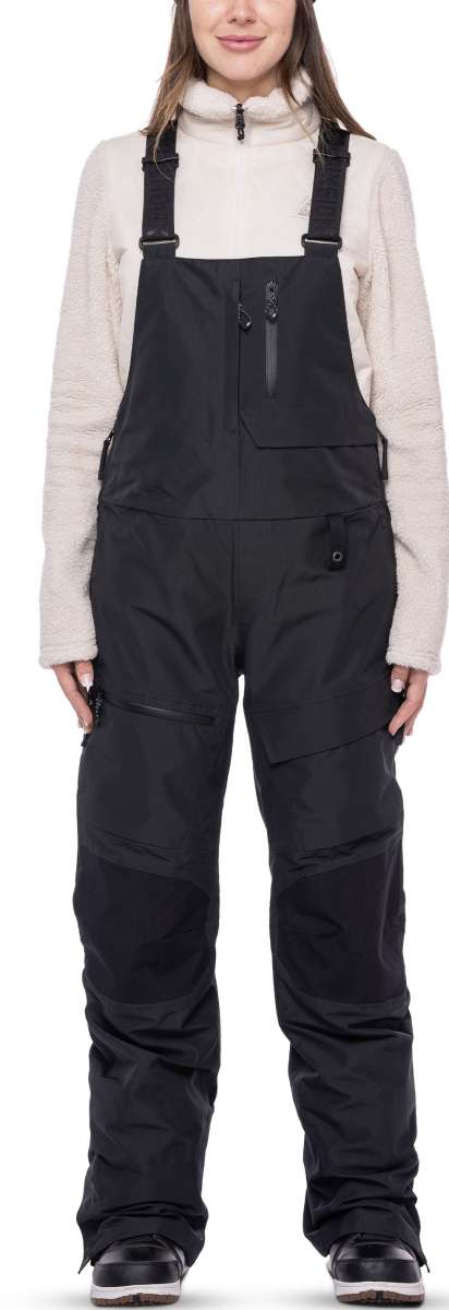 The 686 Women's Geode Thermagraph Bib 2023 bibs are black with an insulated hood and front zip closure.