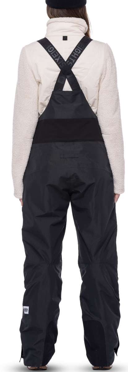 The 686 Women's Geode Thermagraph Bib 2023 bibs are black with a reflective logo on the left leg.