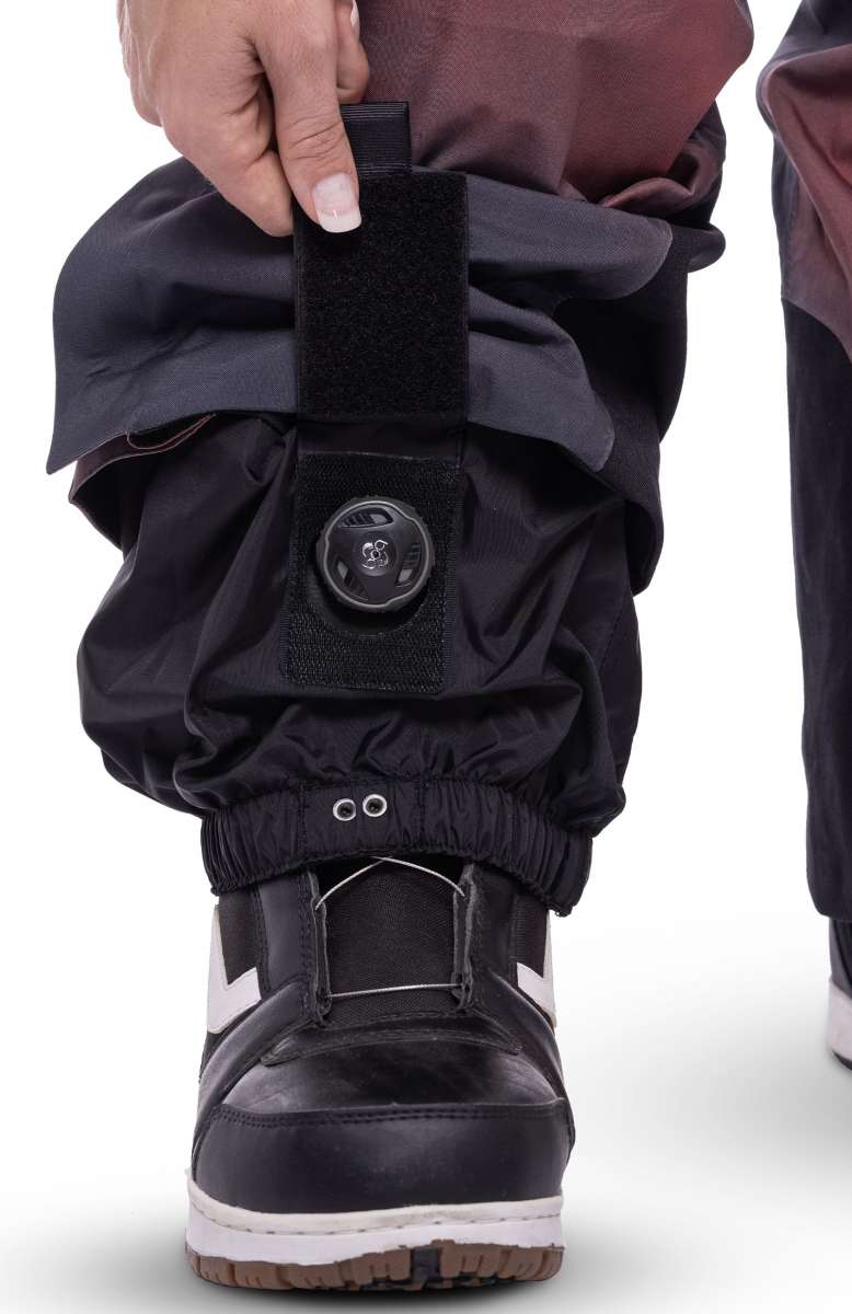 The 686 Women's Geode Thermagraph Bib features a black insulated hood and elastic cuffs in a dark maroon color.