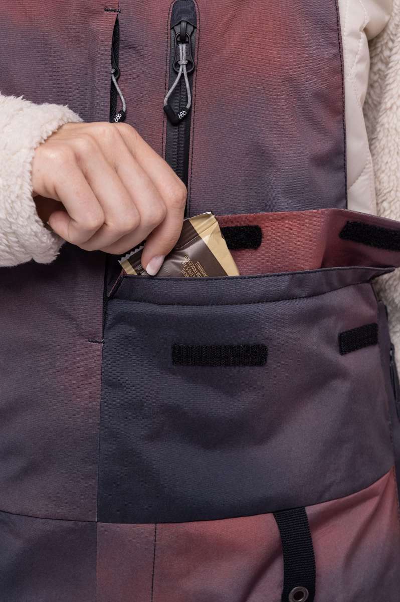 The 686 Geode Thermagraph bib in pink and purple has an insulated hood.