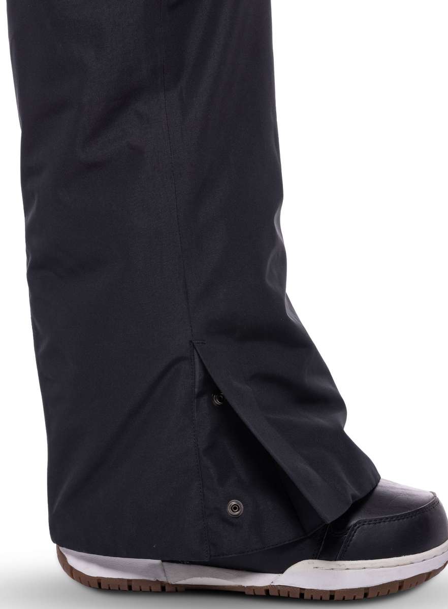 The 686 Women's Geode Thermagraph Bib 2023 features a black color with an insulated hood and is displayed from the side view.